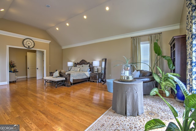 bedroom with vaulted ceiling, hardwood / wood-style floors, and crown molding