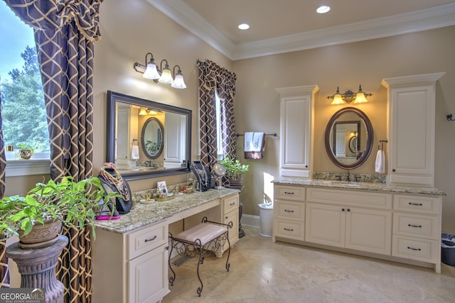 bathroom with crown molding and vanity