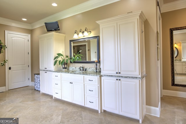 bathroom featuring crown molding and vanity