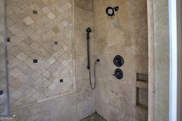 bathroom with a tile shower