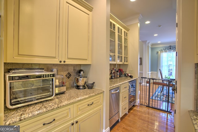 kitchen featuring light hardwood / wood-style floors, tasteful backsplash, stainless steel dishwasher, ornamental molding, and light stone counters