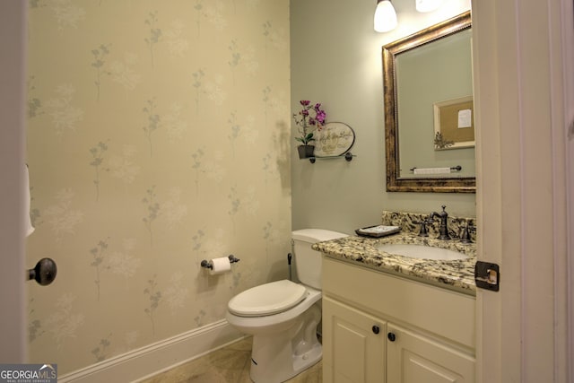 bathroom featuring vanity, toilet, and tile patterned floors