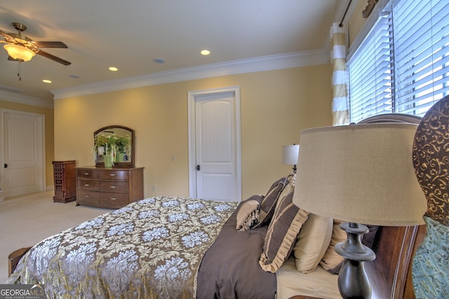 bedroom with ceiling fan, light carpet, and crown molding