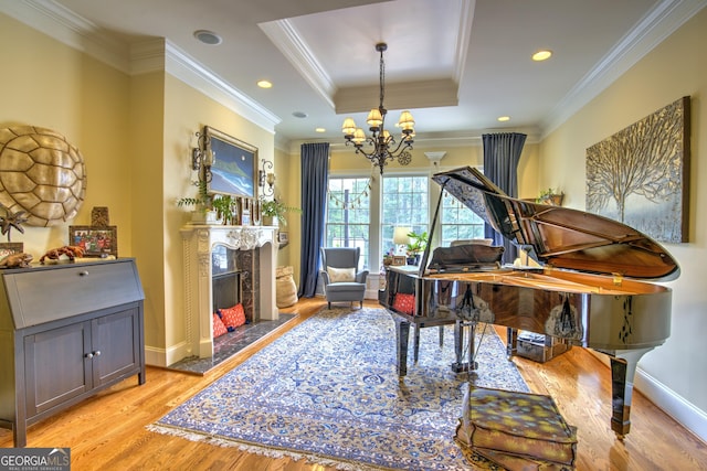 misc room with a raised ceiling, crown molding, and a fireplace