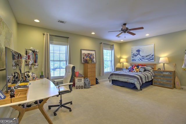 bedroom featuring ceiling fan, carpet floors, and multiple windows