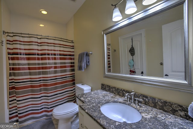 bathroom featuring toilet and vanity