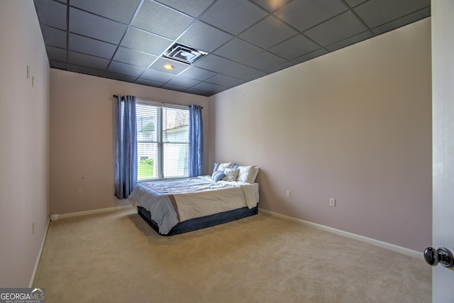 carpeted bedroom featuring a paneled ceiling