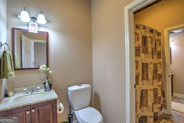 bathroom with toilet and vanity