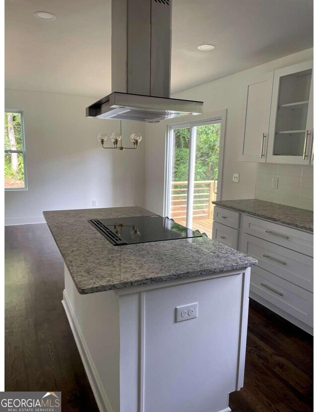 kitchen featuring black electric stovetop, island exhaust hood, dark hardwood / wood-style flooring, and white cabinetry