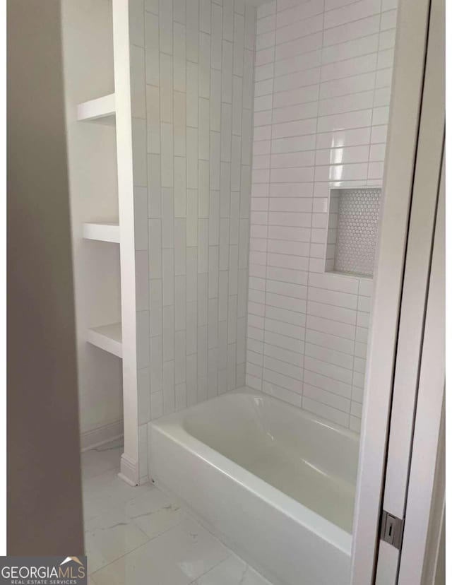 bathroom featuring built in features and tiled shower / bath