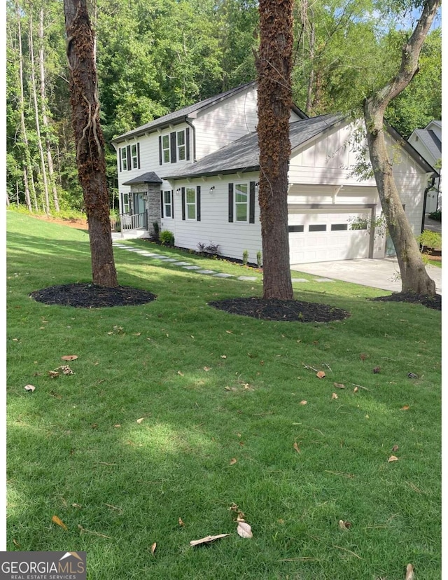 front of property featuring a front lawn and a garage