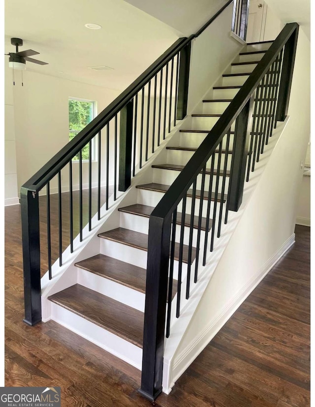 stairway featuring hardwood / wood-style floors and ceiling fan