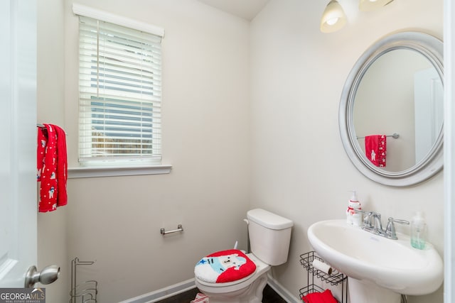 bathroom with sink, toilet, and a healthy amount of sunlight