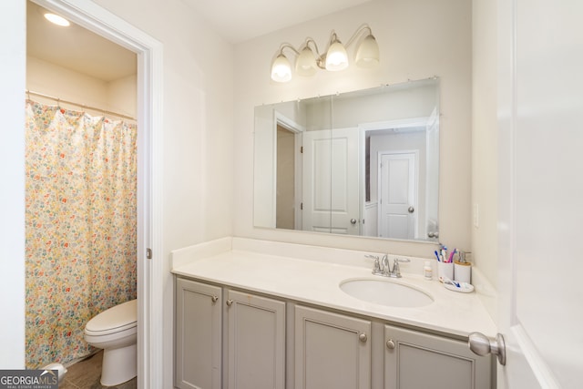 bathroom with vanity, toilet, walk in shower, and tile patterned flooring