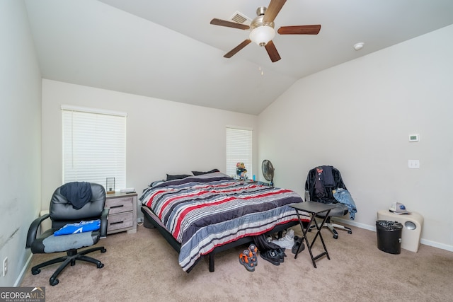 bedroom with ceiling fan, lofted ceiling, and light carpet