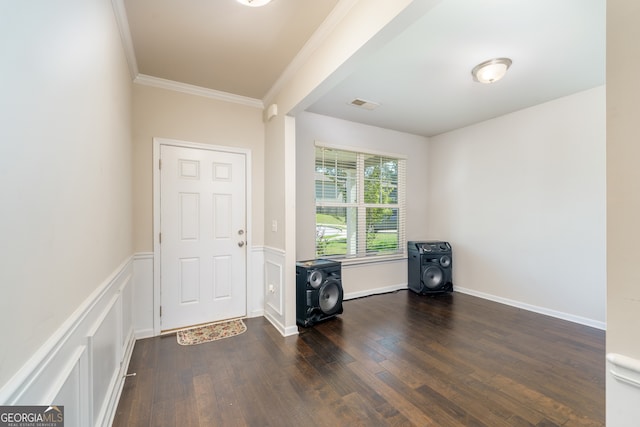 foyer featuring crown molding and dark hardwood / wood-style floors