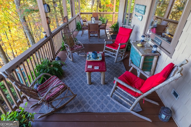 deck featuring outdoor dining area and visible vents