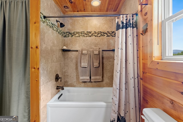 bathroom featuring toilet, wooden ceiling, and shower / tub combo