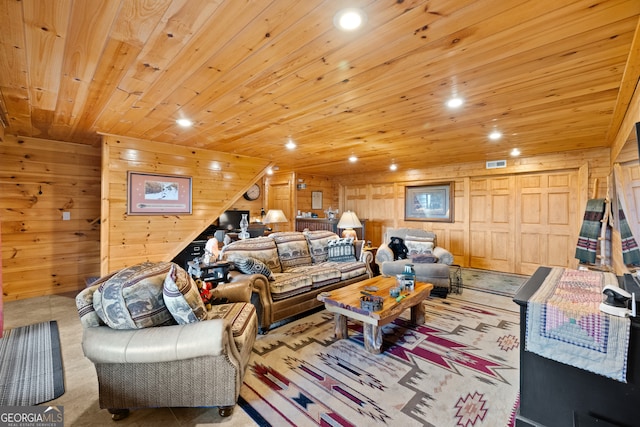 carpeted living room featuring wood walls and wooden ceiling