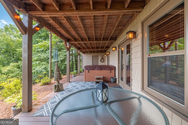 view of patio featuring a hot tub, fence, french doors, and outdoor dining space