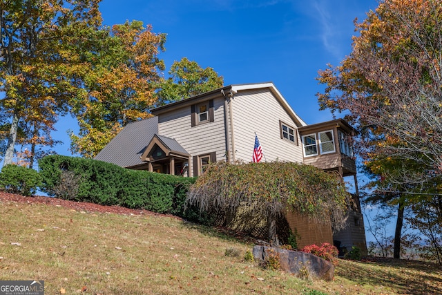 view of side of property with a lawn