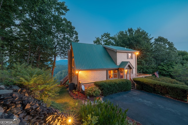 view of front of house featuring central AC unit and metal roof