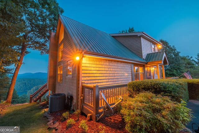 exterior space featuring a mountain view and central AC unit