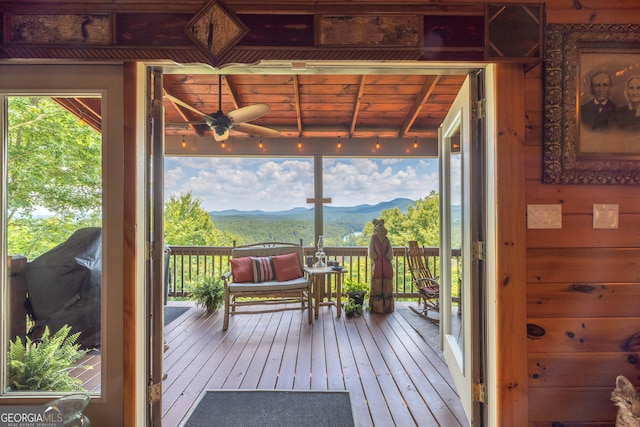 interior space with ceiling fan, a mountain view, and outdoor lounge area