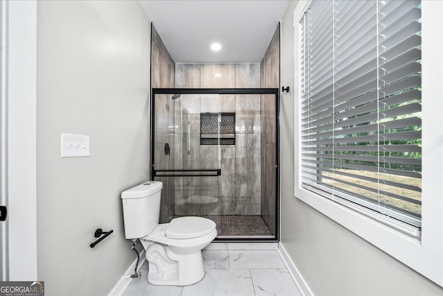 bathroom featuring an enclosed shower and toilet