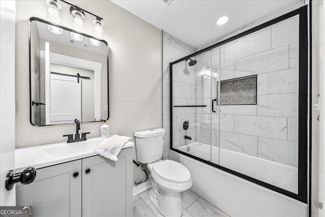 full bathroom featuring vanity, shower / bath combination with glass door, and toilet