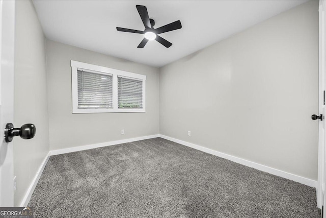 empty room with ceiling fan and dark carpet