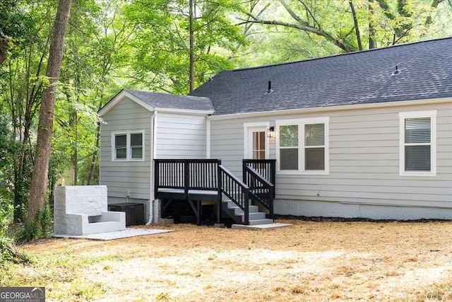 back of property featuring central AC and a deck