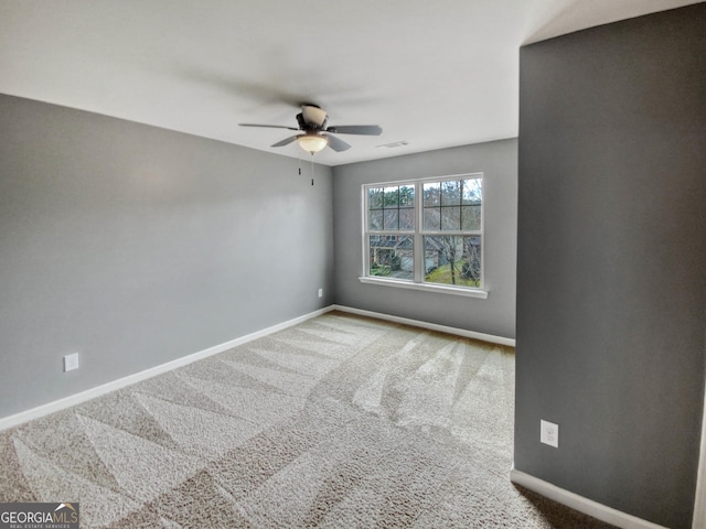 spare room featuring carpet flooring and ceiling fan