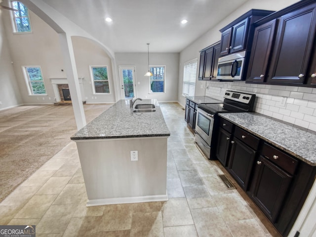 kitchen featuring backsplash, sink, a healthy amount of sunlight, and appliances with stainless steel finishes