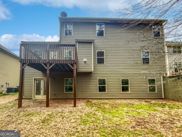 back of house with a wooden deck and cooling unit