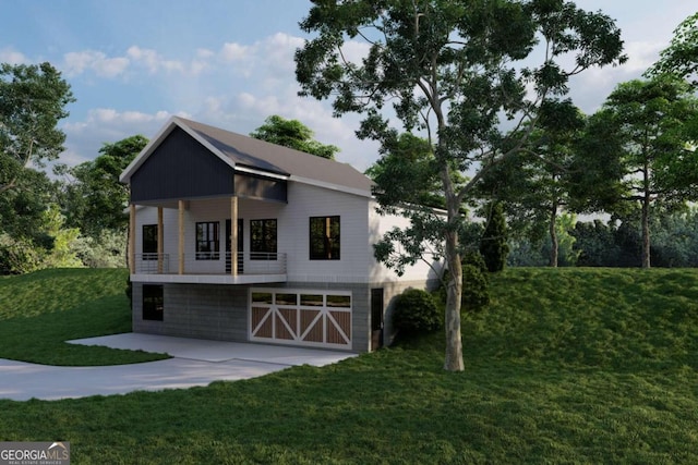 view of front facade featuring a garage, driveway, a balcony, and a front lawn