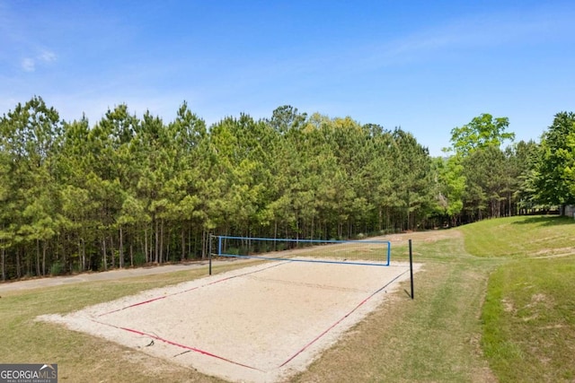 surrounding community featuring a lawn and volleyball court