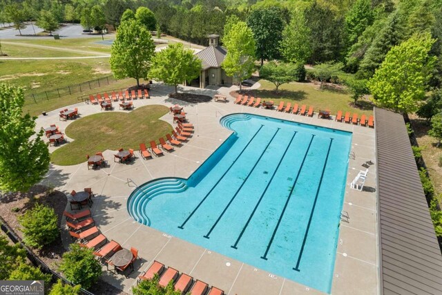 view of swimming pool featuring a patio area and a lawn