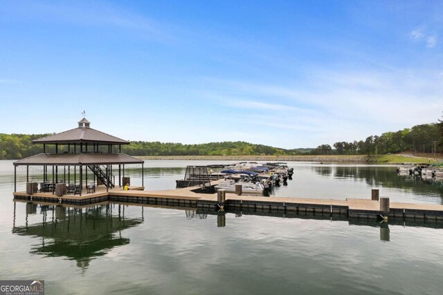 view of dock featuring a water view and a gazebo