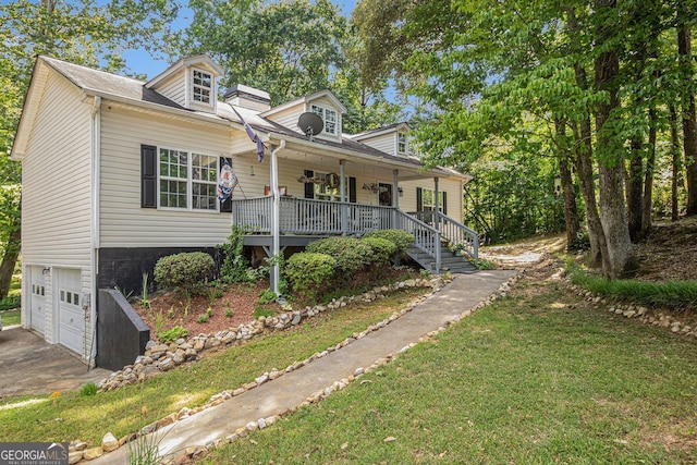 view of front of house featuring covered porch, a garage, and a front yard