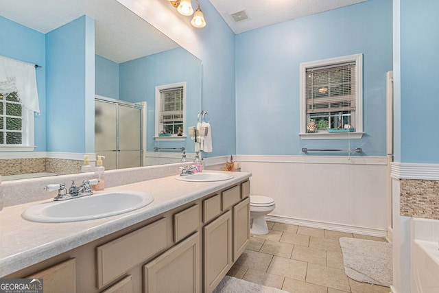 104 Streambank Ct, Temple, GA 30179 - bathroom with wainscoting, a shower stall, double vanity, toilet, and a garden tub