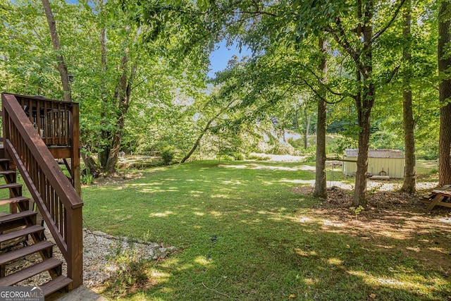 104 Streambank Ct, Temple, GA 30179 - view of grassy yard featuring stairway and a deck