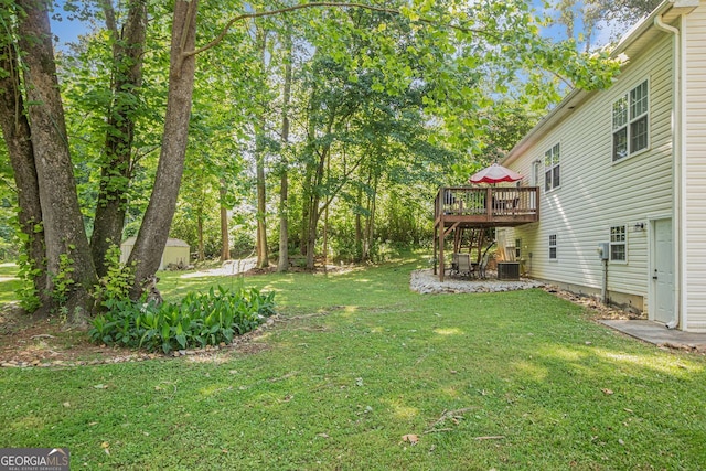 104 Streambank Ct, Temple, GA 30179 - view of green lawn featuring a wooden deck, central AC unit, and a patio