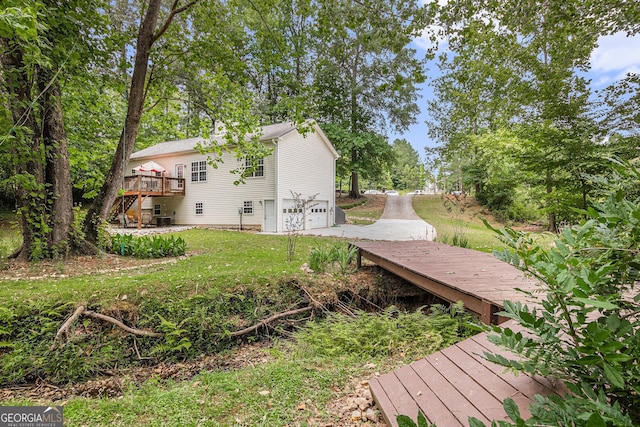 104 Streambank Ct, Temple, GA 30179 - view of green lawn featuring stairway, an attached garage, and a deck