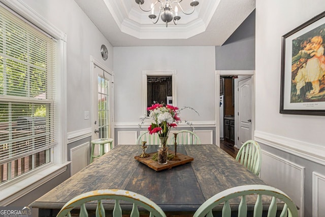 104 Streambank Ct, Temple, GA 30179 - dining space with a chandelier, a wainscoted wall, ornamental molding, a raised ceiling, and a decorative wall