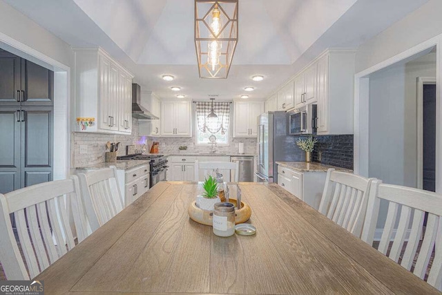 1985 Roscoe Rd, Newnan, GA 30263 - dining space with a notable chandelier and vaulted ceiling