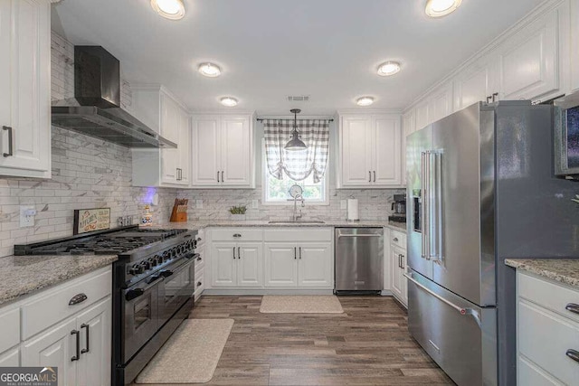 1985 Roscoe Rd, Newnan, GA 30263 - kitchen with dark wood-style flooring, a sink, high quality appliances, white cabinets, and wall chimney range hood