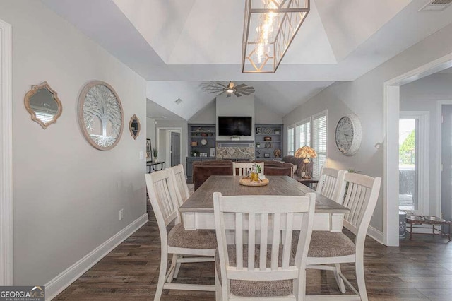 1985 Roscoe Rd, Newnan, GA 30263 - dining area featuring visible vents, dark wood-type flooring, vaulted ceiling, baseboards, and ceiling fan with notable chandelier