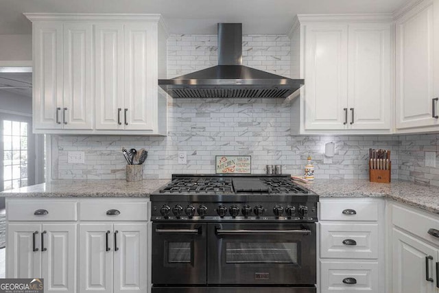 1985 Roscoe Rd, Newnan, GA 30263 - kitchen with wall chimney exhaust hood, range with two ovens, decorative backsplash, and white cabinets