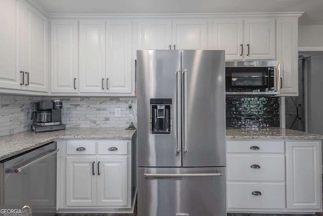 1985 Roscoe Rd, Newnan, GA 30263 - kitchen with appliances with stainless steel finishes, backsplash, and white cabinets